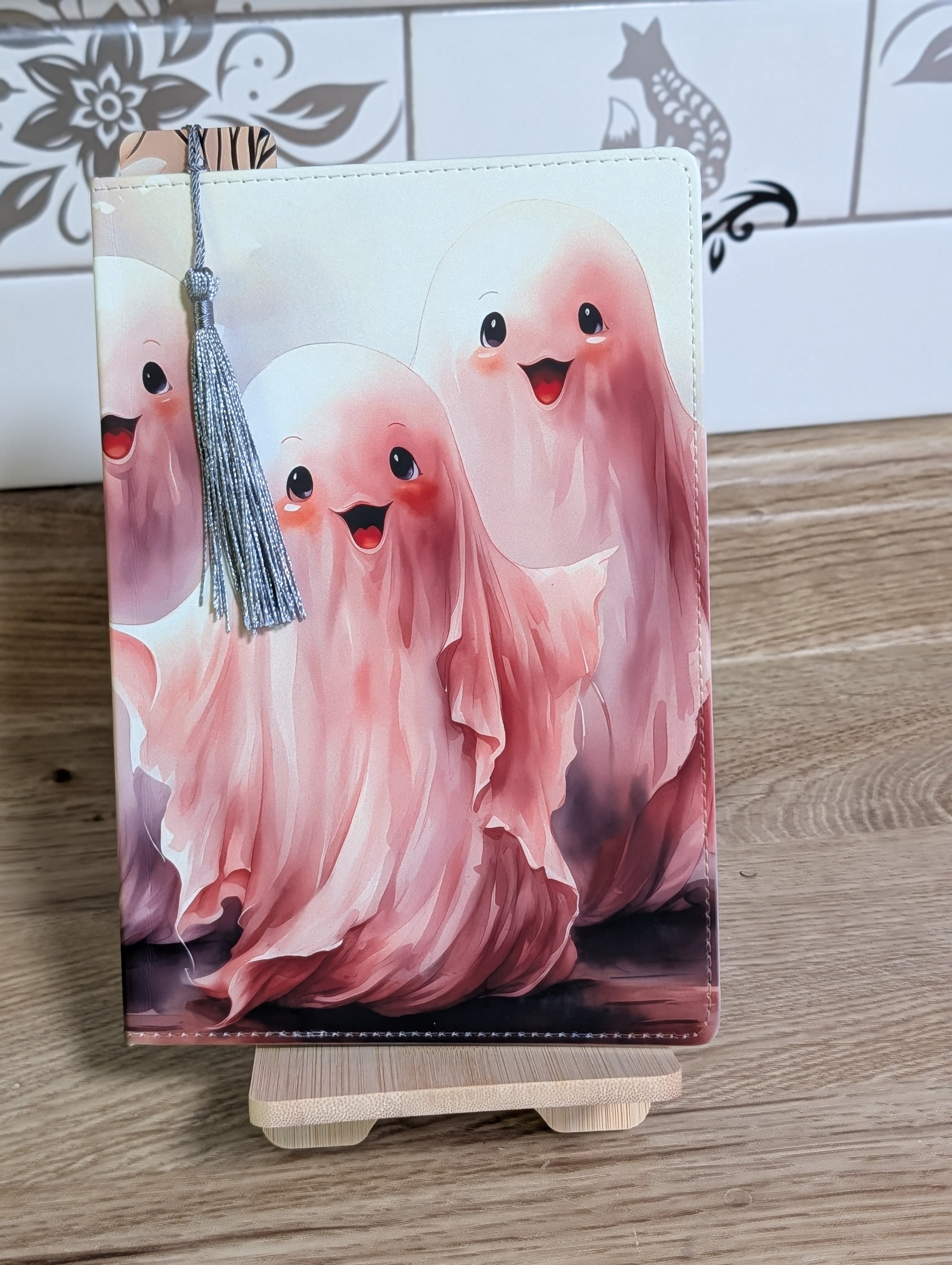 Cute ghost notebook front cover with three pink watercolor ghosts and silver tassel