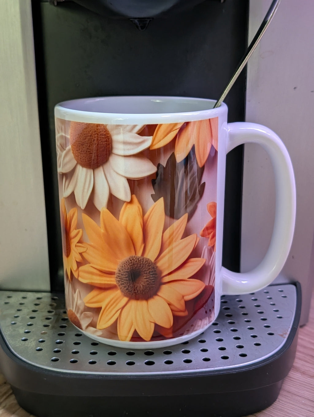 3D sunflower and daisy ceramic mug handle view on wooden stool showing reverse side floral design