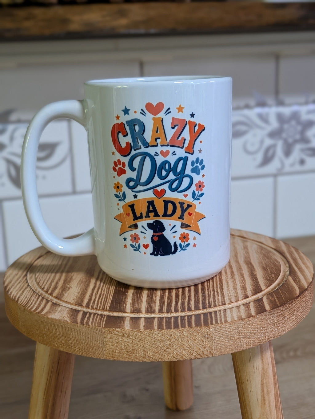 Crazy Dog Lady ceramic mug on wooden stool handle side view showing Crazy Dog Lady design