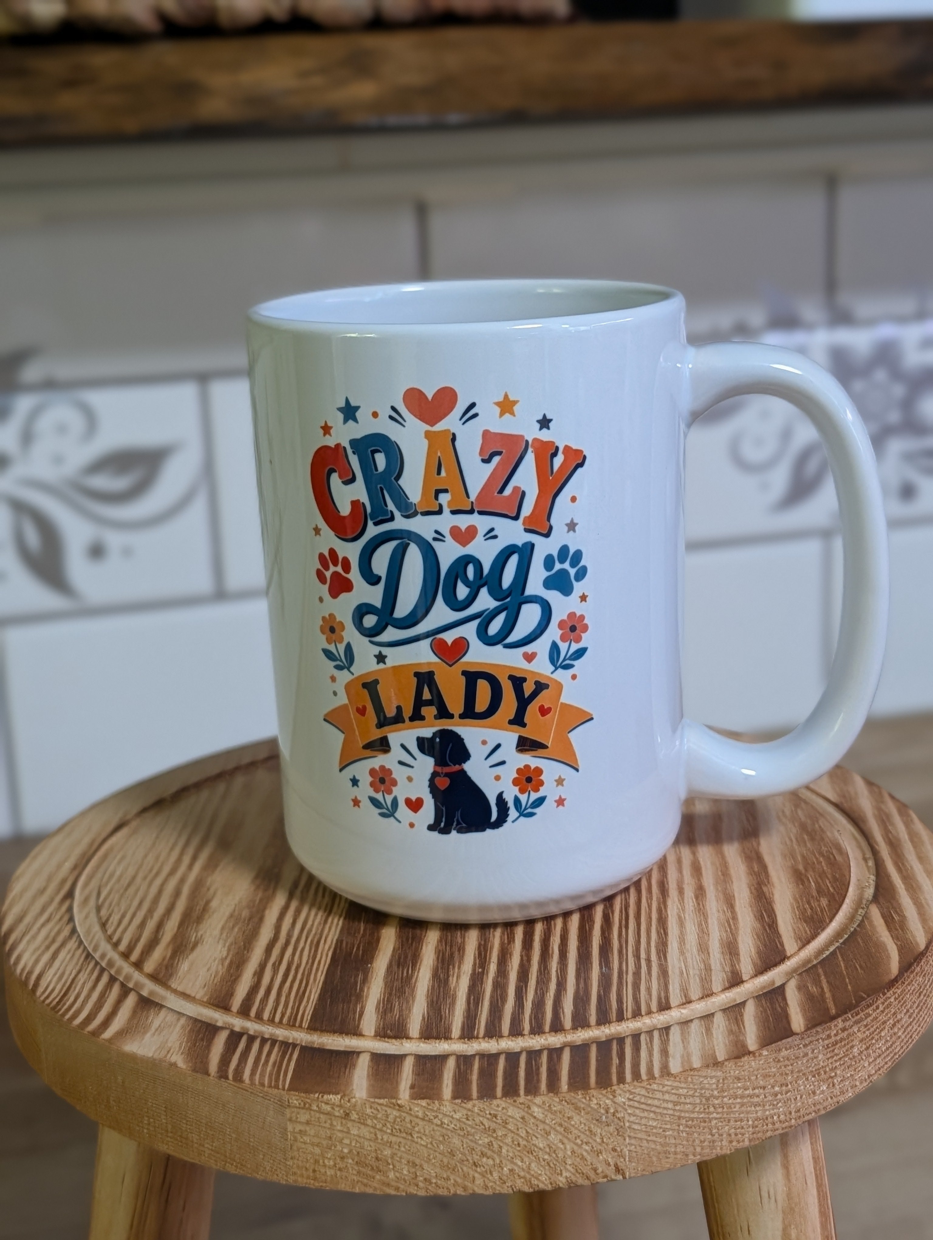Crazy Dog Lady ceramic mug on wooden stool front view showing full design with hearts and florals