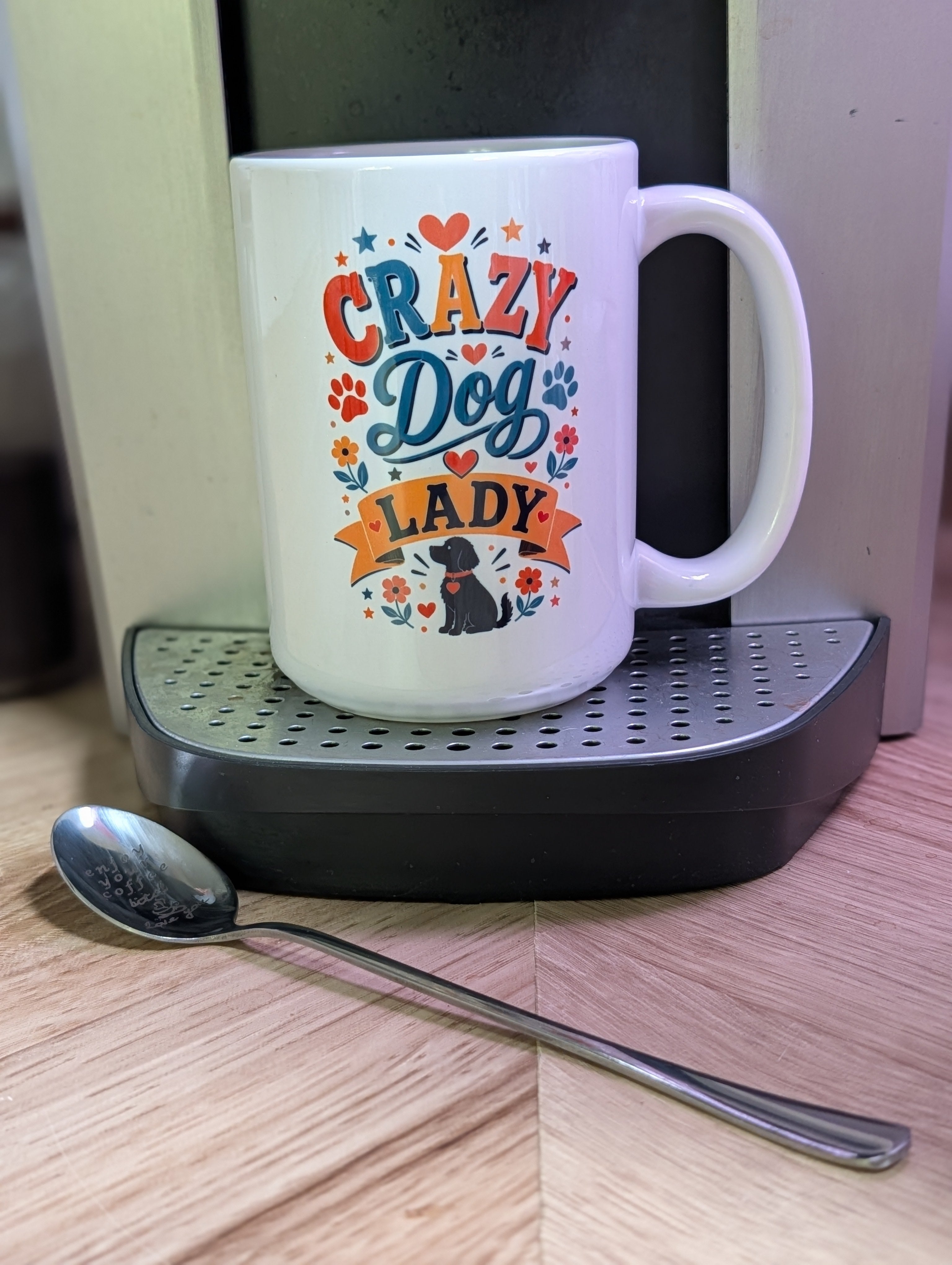 Crazy Dog Lady ceramic mug on coffee machine showing bold colorful Crazy Dog Lady quote with paw prints and black lab