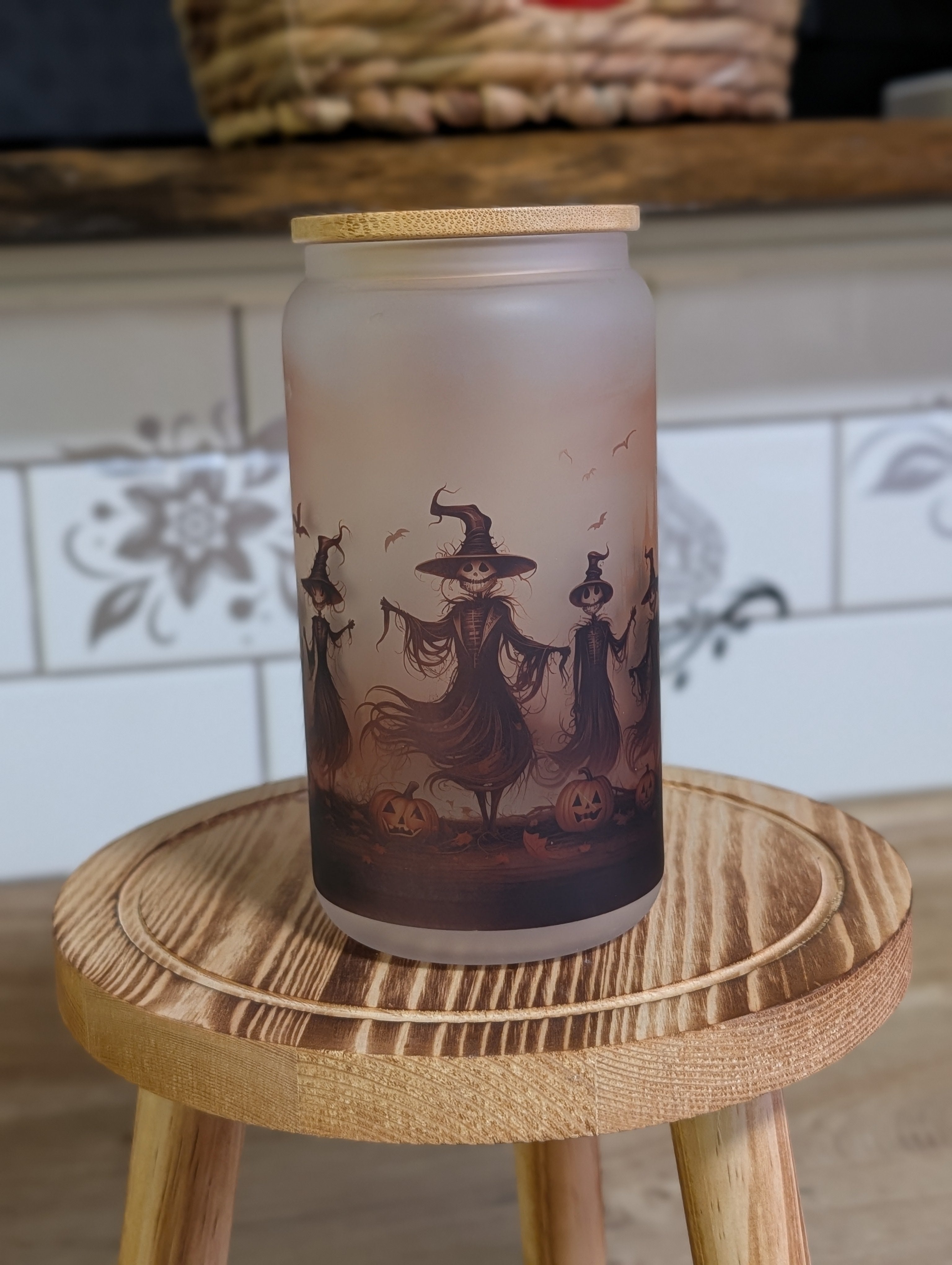 Halloween scarecrow witches frosted glass can close up showing jack-o-lanterns and witch detail