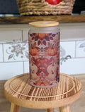 Pumpkin harvest frosted glass can front view with bamboo lid showing orange and white pumpkins with fall leaves