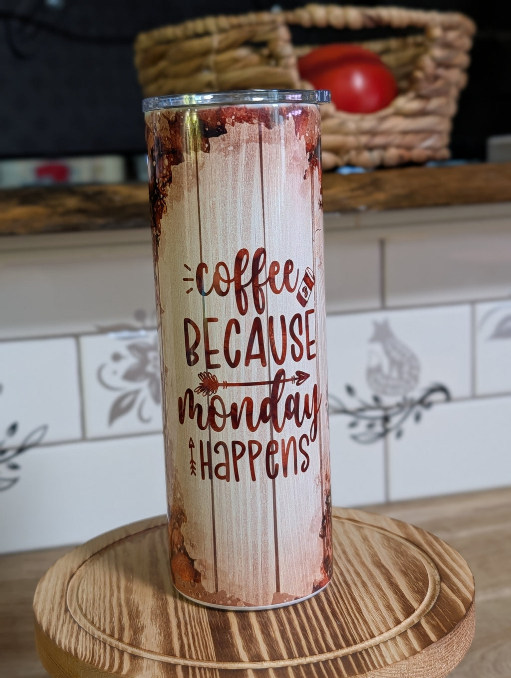 Coffee Because Monday Happens tumbler with lid and straw on wooden stool