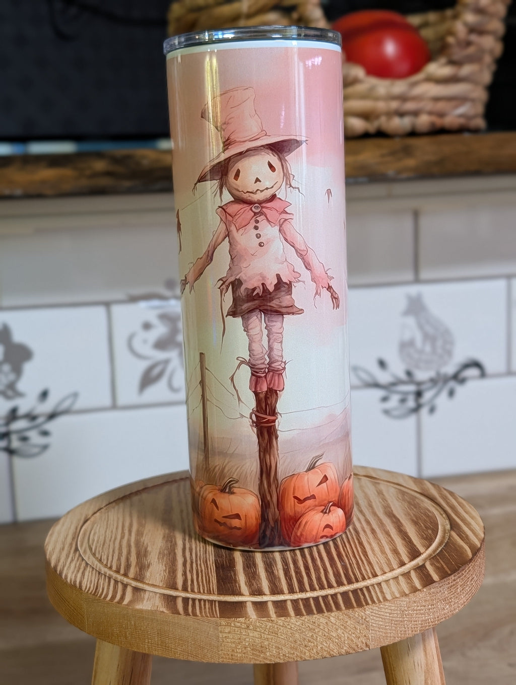 Watercolor scarecrow tumbler front view with lid on showing full scarecrow and pumpkins design