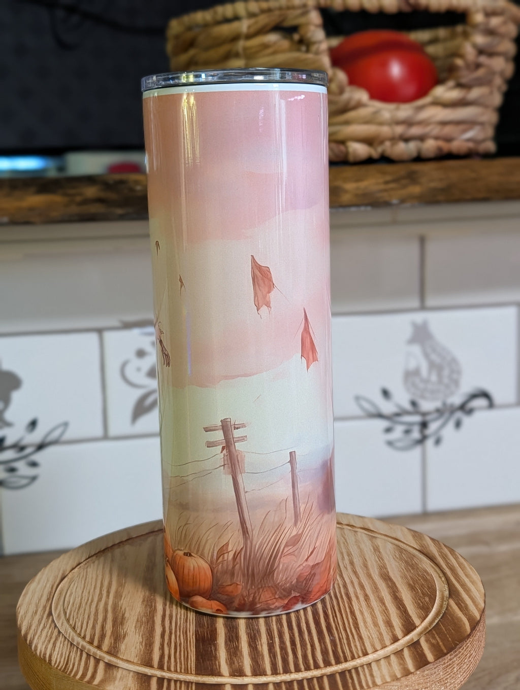 Watercolor scarecrow tumbler reverse side showing autumn fence and falling leaves landscape