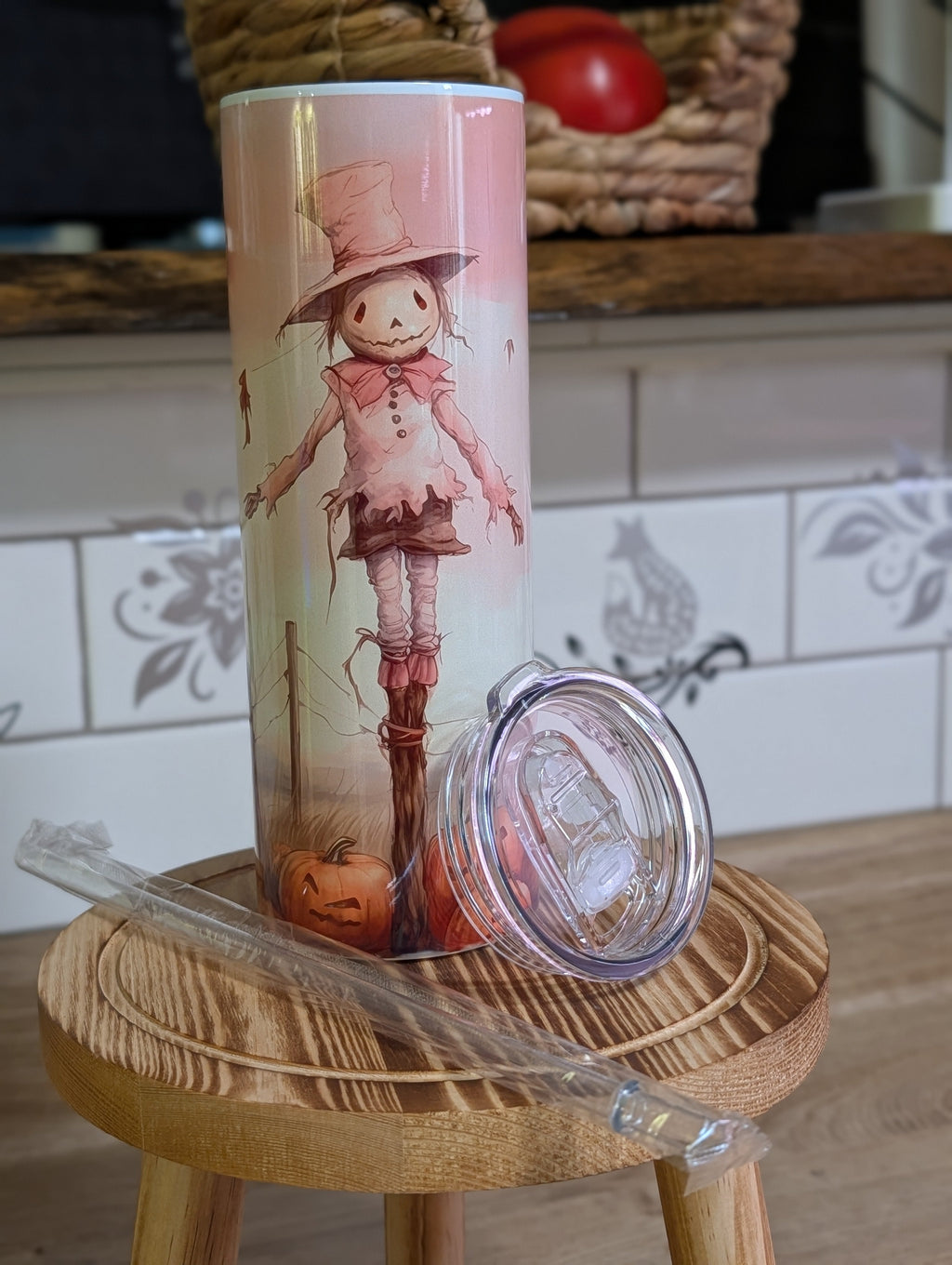 Watercolor scarecrow tumbler front view with lid off and straw laid beside it