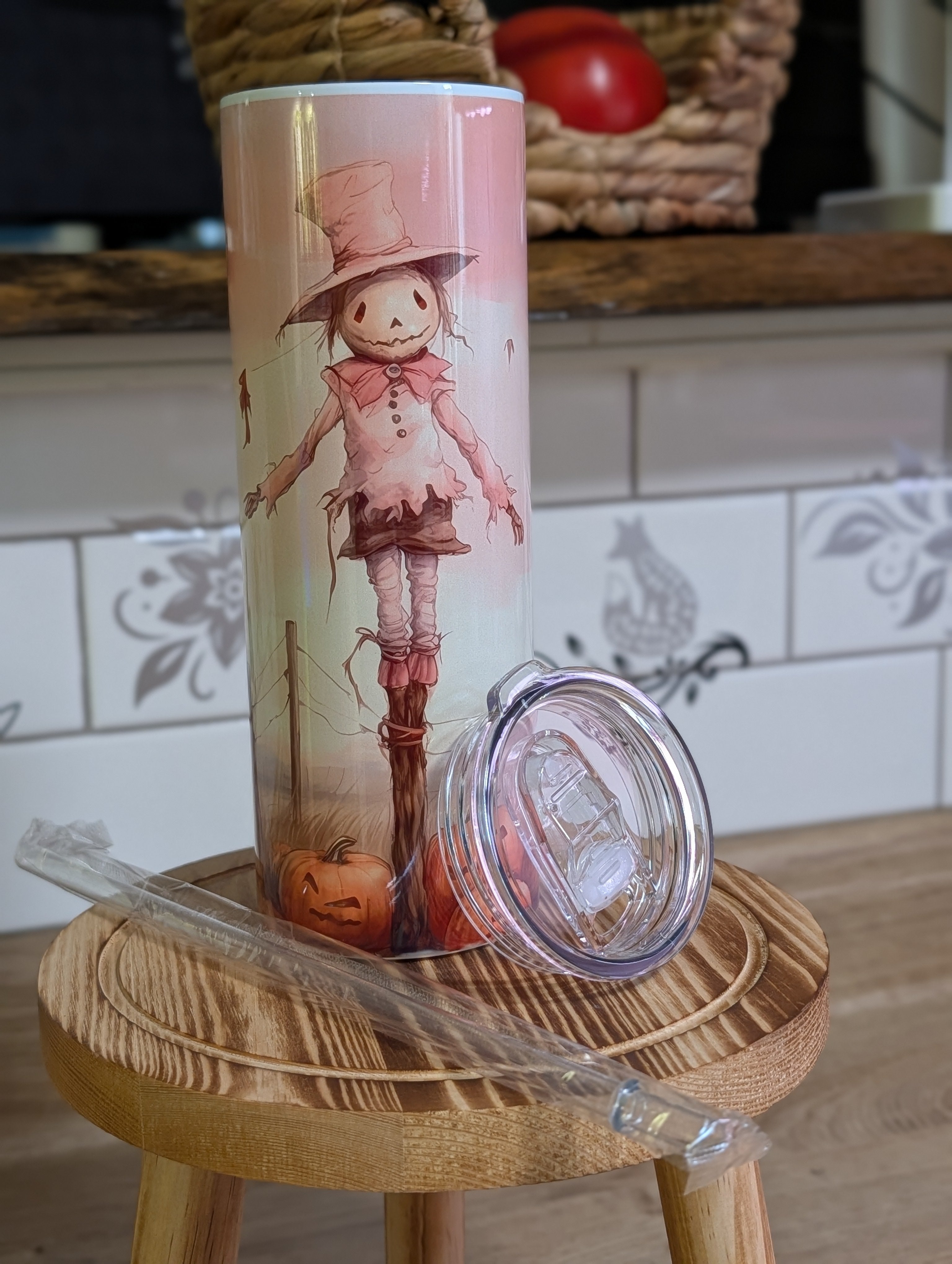 Watercolor scarecrow tumbler front view with lid off and straw laid beside it
