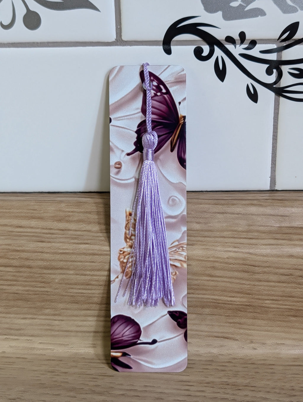 Purple butterfly bookmark - white embossed floral background with deep purple butterfly and lavender tassel