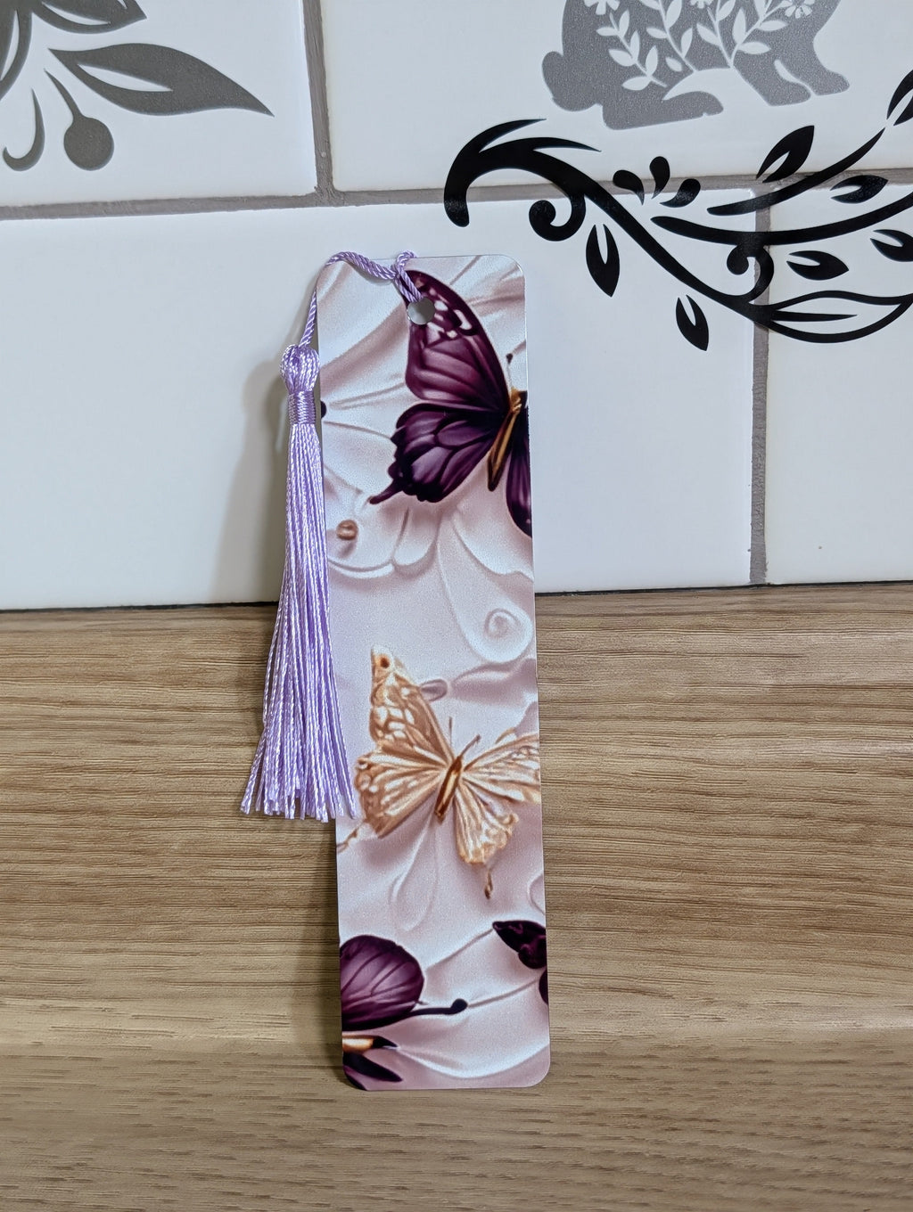 Purple butterfly bookmark side view - purple and gold butterflies on white embossed background with lavender tassel
