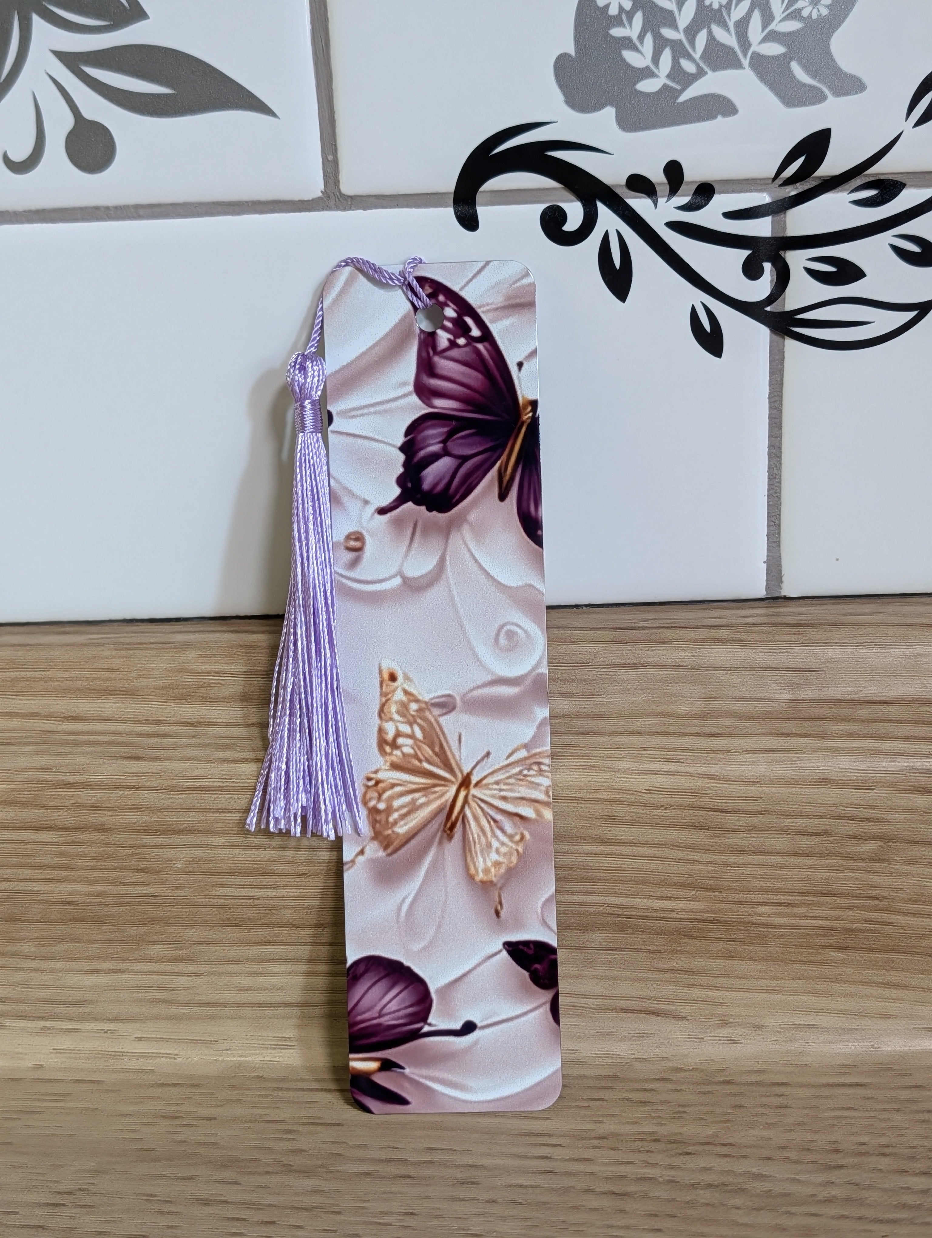 Purple butterfly bookmark side view - purple and gold butterflies on white embossed background with lavender tassel