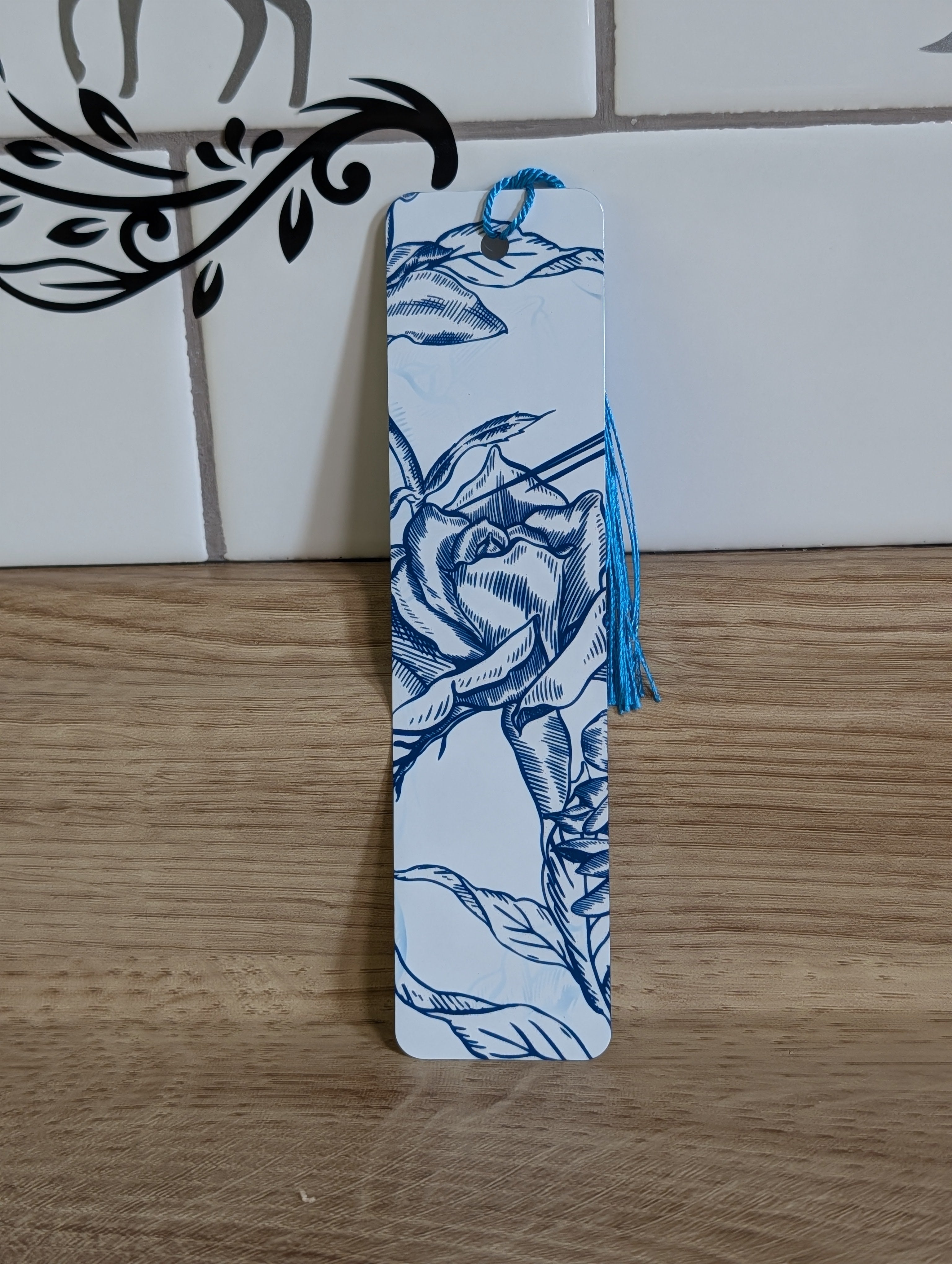 Blue rose etching bookmark front - white background with navy hand-drawn rose illustration and blue tassel