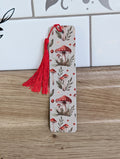 Mushroom bookmark front - neutral background with red toadstool mushrooms and botanical leaves with red tassel