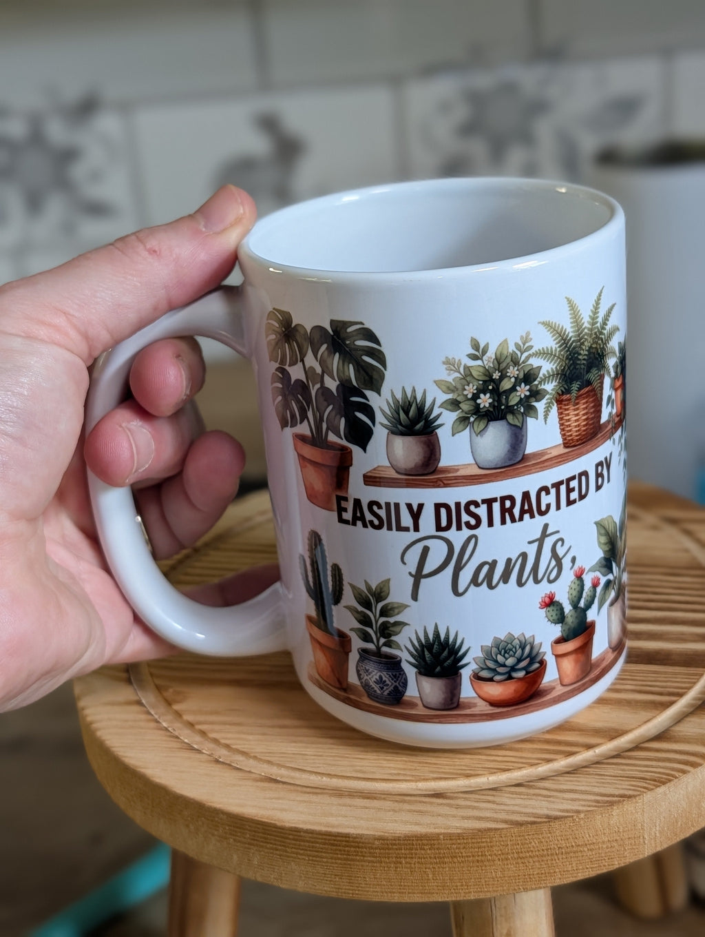 Plant lover mug held in hand showing full wrap watercolor plant design