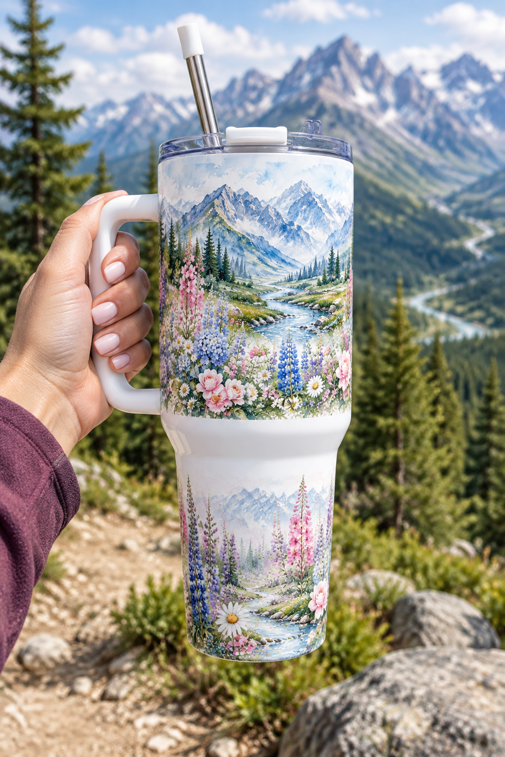 Alpine Wildflowers 40oz tumbler held at mountain trail overlook