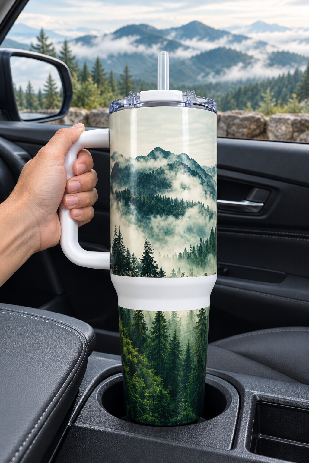 Mountain and pines 40oz tumbler in a parked car